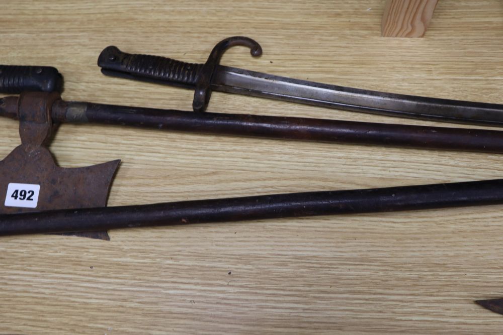 Six bayonets and two axes, largest 99cm